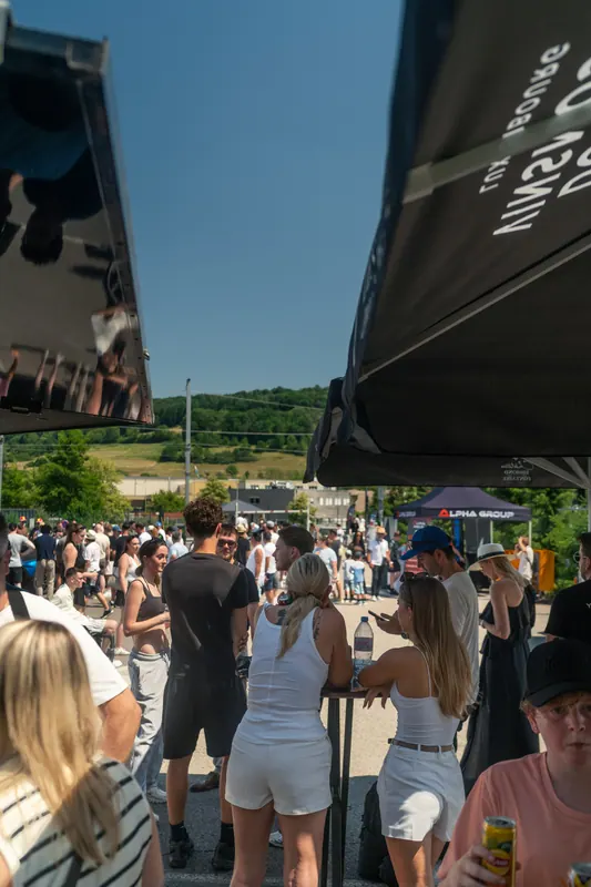 Visitors gathering beside the event tents